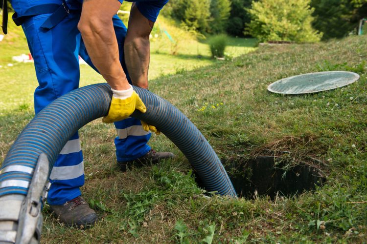 Emptying household septic tank. Cleaning sludge from septic system.